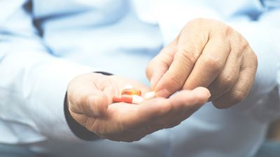 close up of hands holding medication